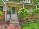Inviting front porch with stone accents, brick walkway, and manicured landscaping at 1733 Piccadilly Dr, Charlotte, NC 28211