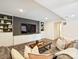 Cozy living room with a plush leather sofa, decorative pillows, and a dark accent wall with built-in cabinets at 1733 Piccadilly Dr, Charlotte, NC 28211