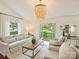 Cozy living room filled with natural light, showcasing a decorative chandelier and stylish decor at 1733 Piccadilly Dr, Charlotte, NC 28211