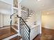 Elegant staircase with modern black metal railings and hardwood steps in a bright home at 1733 Piccadilly Dr, Charlotte, NC 28211