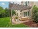 Charming outdoor patio with pergola, comfortable seating, and built-in grill at 1737 Cavaillon Dr, Waxhaw, NC 28173