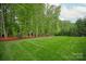 Expansive backyard boasting a well-maintained lawn bordered by mature trees at 1737 Cavaillon Dr, Waxhaw, NC 28173