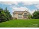 Beautiful backyard view with a pergola-covered patio and manicured lawn, perfect for outdoor living at 1737 Cavaillon Dr, Waxhaw, NC 28173