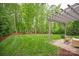 Professionally landscaped backyard with a manicured lawn and a large pergola at 1737 Cavaillon Dr, Waxhaw, NC 28173