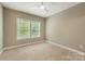 Bedroom featuring a large window, neutral walls, carpet flooring and a ceiling fan at 1737 Cavaillon Dr, Waxhaw, NC 28173