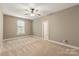 Light-filled bedroom featuring a ceiling fan, neutral walls, and carpet flooring at 1737 Cavaillon Dr, Waxhaw, NC 28173