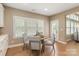 Cozy breakfast nook features a round table, four chairs, and natural light from shuttered windows at 1737 Cavaillon Dr, Waxhaw, NC 28173