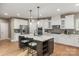 Beautiful kitchen featuring stainless appliances, a kitchen island with seating and stylish pendant lighting at 1737 Cavaillon Dr, Waxhaw, NC 28173