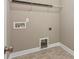 Laundry room with tile floors, utility hookups, and access for dryer vent cleaning at 1737 Cavaillon Dr, Waxhaw, NC 28173