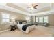 Elegant main bedroom with tray ceiling, plush carpet, and sitting area with large windows at 1737 Cavaillon Dr, Waxhaw, NC 28173