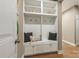 Mudroom with built-in shelving, coat hooks, and bench seating with decorative pillows at 1737 Cavaillon Dr, Waxhaw, NC 28173