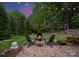 Backyard featuring a stone fire pit, chairs, beautiful landscape and string lights at 20614 Pointe Regatta Dr, Cornelius, NC 28031
