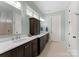 Bathroom features double sinks with dark wood cabinets, white countertops, and tiled floors at 20614 Pointe Regatta Dr, Cornelius, NC 28031