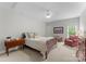 Bedroom featuring a wooden bed frame, soft lighting, and a neutral color palette at 20614 Pointe Regatta Dr, Cornelius, NC 28031