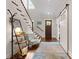 Bright foyer with hardwood floors, staircase, and a decorative sliding barn door to an extra room at 20614 Pointe Regatta Dr, Cornelius, NC 28031
