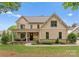 Charming two-story home with a welcoming front porch, landscaped yard, and a stone-accented foundation at 20614 Pointe Regatta Dr, Cornelius, NC 28031