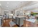 Modern kitchen with stainless steel appliances, island with bar seating, and open access to the dining and living areas at 20614 Pointe Regatta Dr, Cornelius, NC 28031
