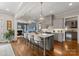 Open-concept kitchen with a large island, pendant lighting, and modern appliances at 20614 Pointe Regatta Dr, Cornelius, NC 28031