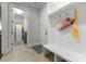 Mudroom with built-in bench seating and storage hooks, with views of the laundry room at 20614 Pointe Regatta Dr, Cornelius, NC 28031
