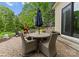 Outdoor patio features wicker chairs, a stone fire pit, and lush landscaping for a relaxing retreat at 20614 Pointe Regatta Dr, Cornelius, NC 28031