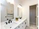 Bright bathroom featuring double sinks, black fixtures, and tile floors at 216 Liriope Ct, Matthews, NC 28105