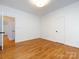 Bedroom with hardwood floors and neutral paint, as well as two closets and a light fixture at 216 Liriope Ct, Matthews, NC 28105