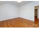 Bedroom with hardwood floors, neutral paint, a light fixture and standard closet doors at 216 Liriope Ct, Matthews, NC 28105