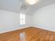 Bright bedroom featuring hardwood floors, neutral paint and a shuttered window at 216 Liriope Ct, Matthews, NC 28105