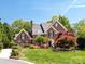 Beautiful brick two-story home with mature landscaping and classic architectural details at 216 Liriope Ct, Matthews, NC 28105
