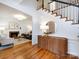 Bright foyer with hardwood floors, staircase, and entryway to the living room at 216 Liriope Ct, Matthews, NC 28105