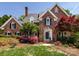 Charming brick home with manicured lawn, colorful azaleas and mature trees at 216 Liriope Ct, Matthews, NC 28105
