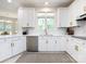 Bright kitchen featuring white cabinetry, stainless steel appliances, and a window providing natural light at 216 Liriope Ct, Matthews, NC 28105