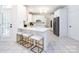 Kitchen with island, white countertops, stainless steel appliances and breakfast bar with three stools at 216 Liriope Ct, Matthews, NC 28105