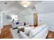 Comfortable living room with neutral decor, hardwood floors, sloped ceilings, and access to another room at 216 Liriope Ct, Matthews, NC 28105