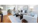 Open-concept living room with modern decor, hardwood floors, and ample natural light at 216 Liriope Ct, Matthews, NC 28105