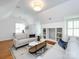 Cozy living room with sloped ceilings, built-in shelving, hardwood floors, and neutral decor at 216 Liriope Ct, Matthews, NC 28105
