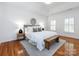 Serene main bedroom with tray ceiling, hardwood floors and decorative rug at 216 Liriope Ct, Matthews, NC 28105