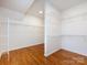 Spacious walk-in closet features hardwood floors and built-in shelving for optimal storage and organization at 216 Liriope Ct, Matthews, NC 28105