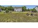 Expansive backyard featuring a fire pit area and playset perfect for outdoor enjoyment and entertaining at 2206 Mills Harris Rd, Wingate, NC 28174