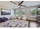 Bedroom offers a decorative rug, 3 windows, a teepee and seating, along with wood floors at 2206 Mills Harris Rd, Wingate, NC 28174
