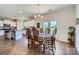 Open dining room with hardwood floors, a large table, french doors and a view into the kitchen area at 2206 Mills Harris Rd, Wingate, NC 28174