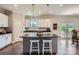 Bright eat-in kitchen with an island, pendant lighting, granite counters, white cabinets, and stainless steel appliances at 2206 Mills Harris Rd, Wingate, NC 28174