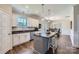 Open kitchen boasts white cabinets, granite countertops, stainless appliances, and a convenient island with barstool seating at 2206 Mills Harris Rd, Wingate, NC 28174