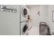Efficient laundry room with stacked washer and dryer, and built-in cabinetry at 2206 Mills Harris Rd, Wingate, NC 28174