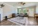 Cozy living room featuring a large sectional sofa, area rug, and ample natural light at 2206 Mills Harris Rd, Wingate, NC 28174