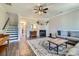 Inviting living room with a fireplace, staircase, and stylish decor, creating a warm and welcoming atmosphere at 2206 Mills Harris Rd, Wingate, NC 28174