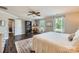 Light-filled bedroom with wood floors, ceiling fan, and two windows with natural light at 2206 Mills Harris Rd, Wingate, NC 28174