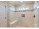 Modern tiled shower with glass door, bench seating, and decorative tile work at 2206 Mills Harris Rd, Wingate, NC 28174
