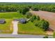 Aerial view of home with fencing, sheds, landscaping, and gravel driveway at 2225 Corinth Church Rd, Monroe, NC 28112