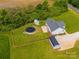 Aerial view of home with fencing, pool, sheds, landscaping, and gravel driveway at 2225 Corinth Church Rd, Monroe, NC 28112